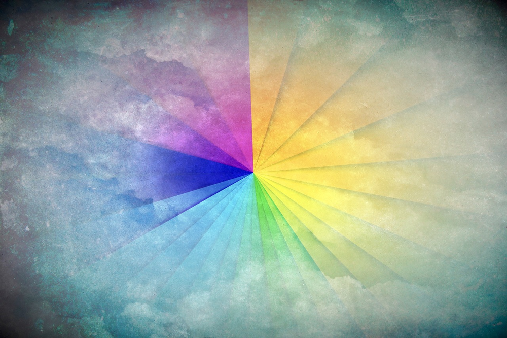 An abstract art background featuring a rainbow-colored radial gradient on a grainy textured canvas